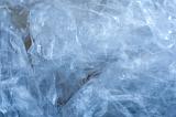 Close up on wrinkled clear blue tinted plastic wrap as abstract background with copy space