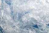 Unique background composed of bunched plastic bags against a blue surface