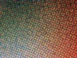 Full frame background pattern of blurry or soft focused halftone dots representing a green to red gradient