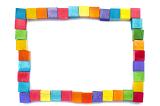 Rectangular frame of colorful wooden blocks or cubes in the colors of the rainbow on a white background with copy space