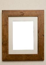 Empty plain rustic wooden picture frame with a beige colored interior mount board and copy space on a neutral beige background