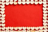 Romantic wooden hearts frame on a red background with copy space for your wedding, anniversary or Valentines concept