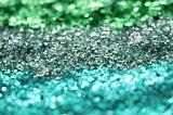 Background texture of green and cyan glitter for creative handicraft or for use as a festive holiday or celebration background arranged in diagonal stripes