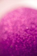 Diffuse curved pink glitter ball in a soft defocused background with copy space above