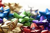 An assortment of metallic gift wrapping bows in various bright colours