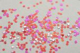 red and pink glitter scattered on a white background