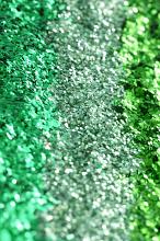 Shiny green glitter background texture in shades of green and emerald arranged in vertical lines for a restive or craft concept