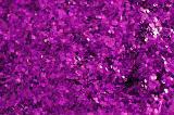 A vivid coloured background of purple coloured sparkling glitter