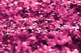 Abstract Background - Close Up of Colorful Magenta Pink Glitter Scattered Full Frame in Selective Diffuse Focus with Copy Space