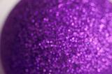 defocused image of a purple glitter covered bauble