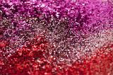 a background of sparkling red and pink coloured glittter