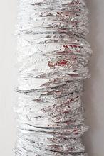 Silver cylindrical duct or tube covered in foil for heat retention in a close up view over a grey background