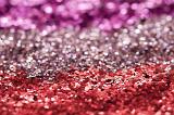 a background of coloured glitter in three colours