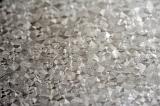 Extreme macro view close up on angular small particles in galvanized steel as background with copy space