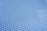 background composed from close up of plastic mat with rows of circles pressed into it