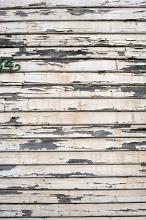 exterior wall of a wooden house with flaked paint