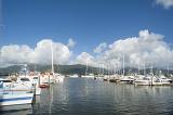 Scenic view of Cairns marina with pleasure boats, sailboats and yachts moored in the sheltered water on a sunny summer day