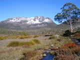 Overland trail with snow on the summit of Mount Ossa, Tasmania, Australia in a scenic landscape wilderness view, travel and tourism concept