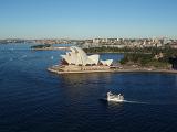 Panoramic landscape view of Sydney opera house and the harbour with boat traffic in the bay, Sydney, Australia, in a tourism and travel concept