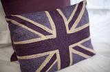 British themed bedroom with a colorful cushion bearing the Union Jack or Union Flag of the United Kingdom, close up of the cushion or pillow on the bed