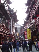Busy Street Scene in Area of City Lined with Traditional Chinese Architecture on Hazy Day, China