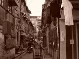 a narrow street in a poor area of china