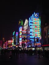 Colorful neon advertising signs and lights on buildings in China shining brightly in the night in a commercial district