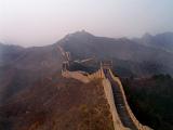 Scenic landscape view of the Great Wall of China stretching away across the mountain peaks into the mist in the distance