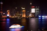 Long Exposure of Shanghai at Night - Blurred Boat on River Traveling Past Illuminated Skyline of Shanghai, China