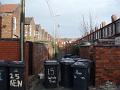moss side: wheelie bins line the back streets of urban manchester