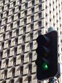 green traffic signal and office building, symbolic of green light for commerce and business