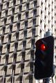 a red traffic signal of office windows, metaphor of stopping business, commerce or trade