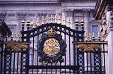 Gate of Buckingham Palace decorated with golden crown, emblem and iron wreath, London royal residence of the monarchy of the United Kingdom