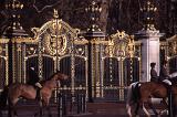 Equestrian Riders on Horseback Riding Past Ornate Golden Gates of Buckingham Palace, City of Westminster, London, England