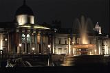 a view of the national gallery and fountains of trafalgar square at night