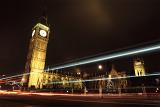 Westminster and Big Ben at the Houses of Parliament, London illuminated at night with vehicle light trails in the foreground
