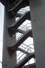 Open concrete staircase with railings outdoors viewed from low angle