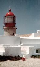 Red lighthouse and white building walls at Cape St.Vincent in Portugal