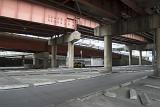 Urban wasteland under flyover motorways with empty space and streets devoid of both cars and people