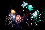 Colorful fireworks display in a night sky with exploding rockets showering fiery sparks celebrating Bonfire Night or Guy Fawkes on 5th November