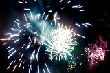 Colorful pyrotechnics display of bursting fireworks in a night sky celebrating a holiday or festival