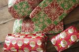 Colorful selection of gift wrapped Christmas presents in boxes on a wooden table or floor