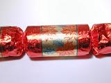 Colorful red Christmas cracker for a festive table decoration to be pulled to release the surprise hidden inside