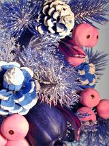 Detail of Glitzy Christmas Decoration - Close Up of Purple Plastic Evergreen Tree Branches Accented with Painted Pine Cones, Baubles and Sparkling Glitter