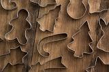Background of festive cookie cutters for the Christmas holiday season arranged on a wooden table in full frame view