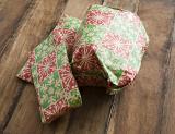 Pile of festive Christmas gifts in colorful wrapping on a wooden table viewed high angle