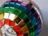 Detail of Festive Disco Ball Bauble Decorated with Colorful Mirrored Tiles in Rainbow Pattern