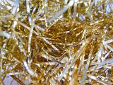 Glittering gold tinsel background texture in a close up view for your Christmas or festive celebration