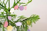 close up on round paper decorations hanging on a christmas tree