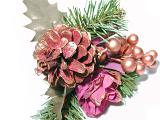 Pine cone Christmas decoration with fake holly berries and flower in shades of pink on greenery , isolated on white
